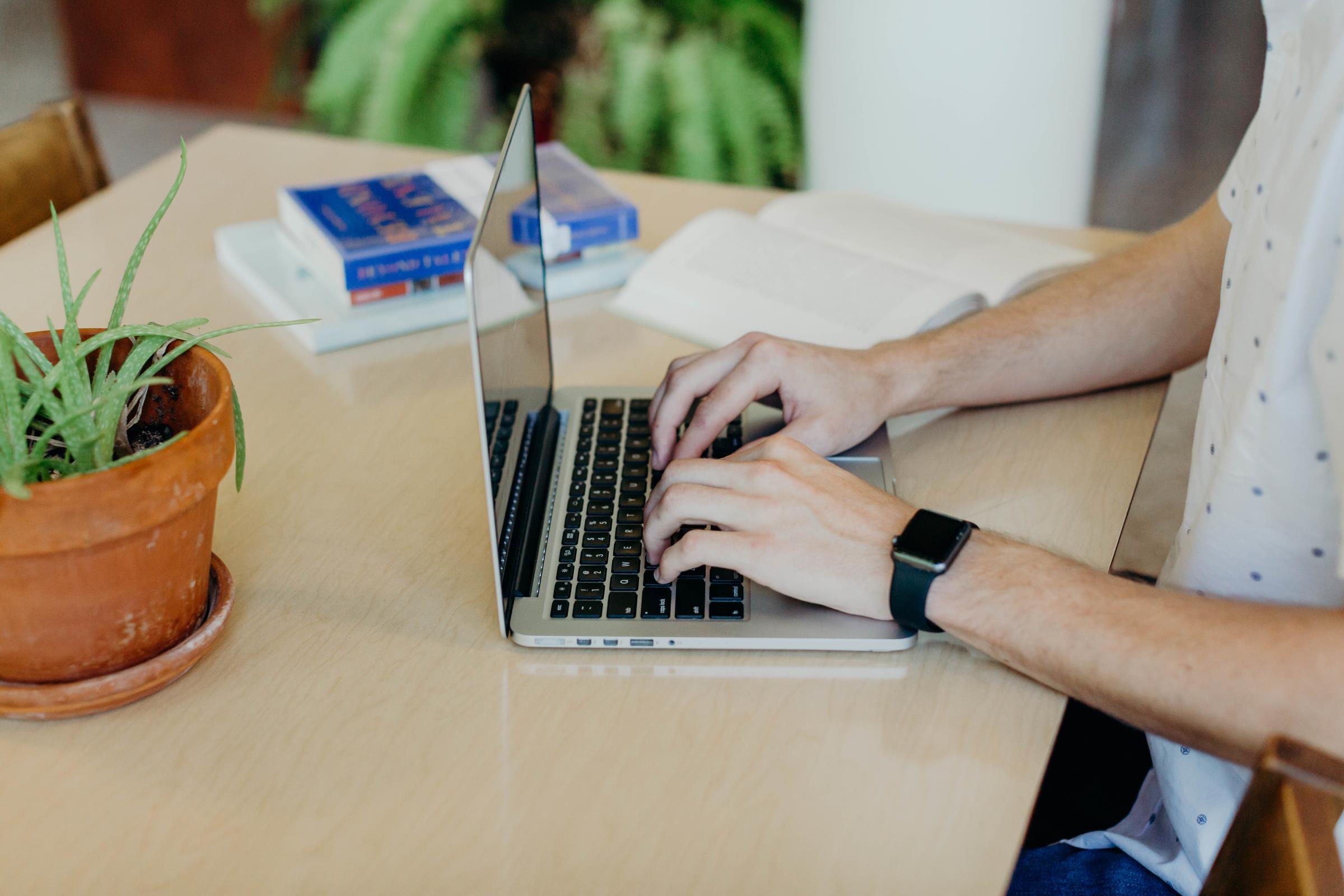 Student typing on a laptop